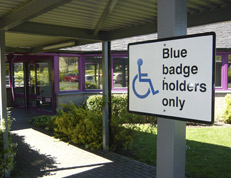 Entrance to building with blue badge sign